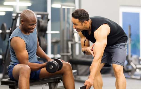 middle aged personal trainer training client